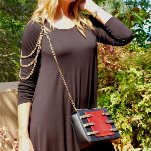 black & red leather grab bag with metal crossbody sling with metal shoulder accessory